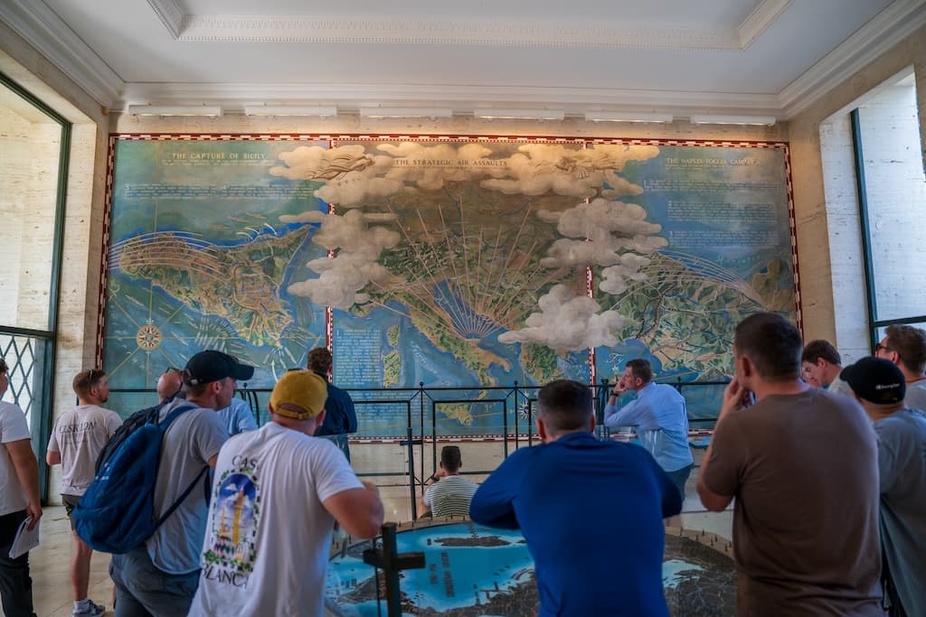 Visitors studying a mural during a battlefield tour
